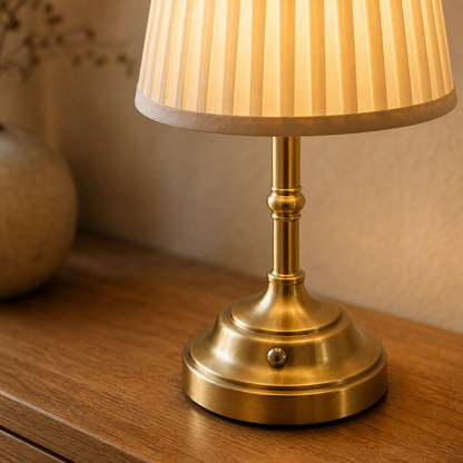 Close detail of gold Nordic rechargeable table lamp shade, base, and touch control.